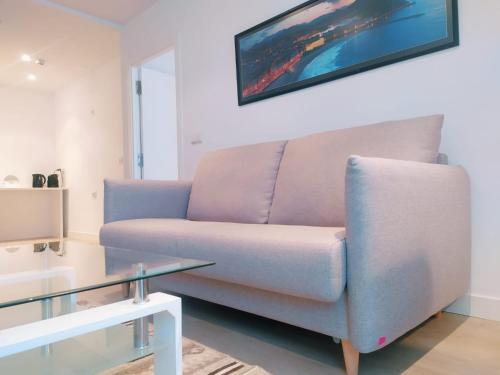a living room with a couch and a glass table at Pensión Sarriegi in Donostia-San Sebastián