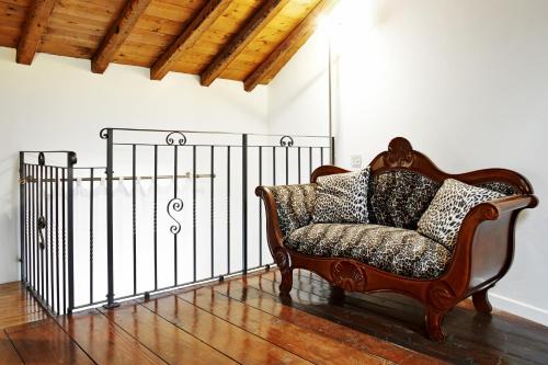 a couch in a room with a iron gate at P&P Piazza Bergamo Apartment in Bergamo
