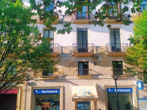 a building with balconies on the side of it at Pensión Sarriegi in Donostia-San Sebastián