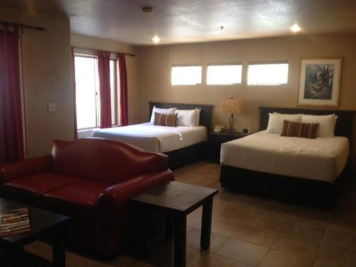 a hotel room with two beds and a couch at Gold Canyon Golf Resort in Gold Canyon