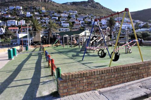 a playground with swings at South Peninsula Beach Apartment in Cape Town