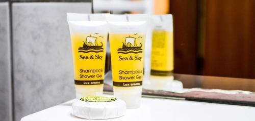a group of two bottles of sunscreen on a counter at Hotel Alos in Almirós
