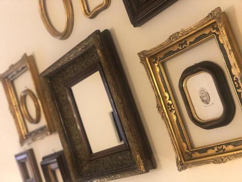 a group of framed pictures on a wall at Little Liberty Loft in Barberino di Mugello
