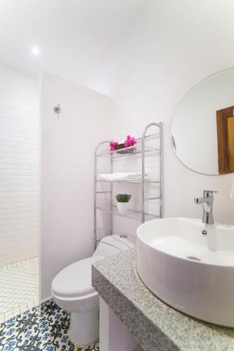 a bathroom with a white toilet and a sink at Hotel Villa del Mar Tradicional in Puerto Vallarta