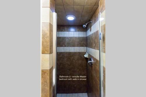 a bathroom with a shower with a glass door at Puget Sound View, Best Area, 2 Baths, 2 Bedrooms, WD, Jacuzzi Bath, New Carpet, Balcony, View, 925sf in Tacoma