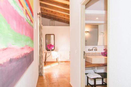 a bathroom with a large painting on the wall at Finca Bonita in Son Servera
