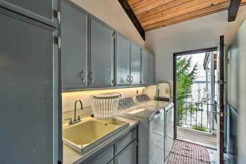 a kitchen with a sink and a window at Quiet Beachfront Family Home with Mt Rainier Views! in Shelton