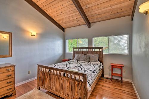 a bedroom with a wooden bed with a wooden ceiling at Quiet Beachfront Family Home with Mt Rainier Views! in Shelton