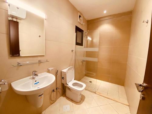 a bathroom with a toilet and a sink at Al Hayat Al Marina Suites in Tabuk