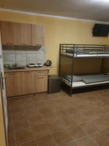 a kitchen with two bunk beds in a room at Hostel Zacisze 2 in Głubczyce