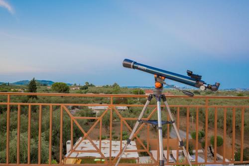 a telescope sitting on top of a building at Villa Status in Vouyiáton