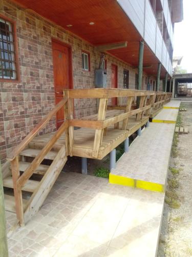 a wooden staircase on the side of a building at Habitaciones y Apartamentos el Caleuche El Tabo in El Tabo