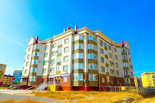 a large building in the middle of a city at Уютная квартира в ЖК Bir Group Актобе in Aktobe