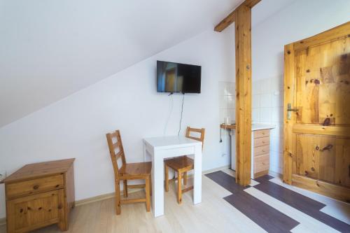 a room with a table and chairs and a tv at kaszuby-Grzonka in Bytów