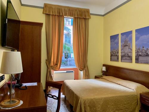 a hotel room with a bed and a window at Actor Hotel in Genoa