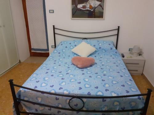 a bed with a heart shaped pillow on it at A casa di Adele in Caserta