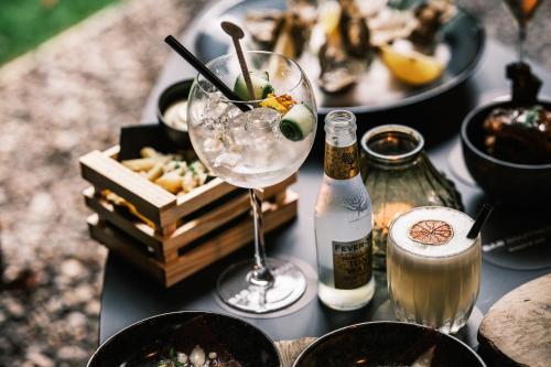 a table topped with plates of food and a wine glass at Boutiquehotel 't Fraeyhuis - adults only in Bruges