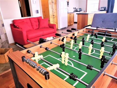 a living room with a table with a large foosball at La plus belle vue du secteur - La Forteresse in Petite-Rivière-Saint-François