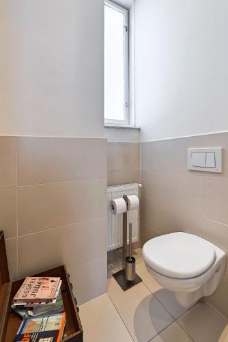 a bathroom with a toilet and a window at 6 rooms in Vienna