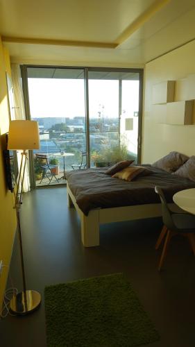 a bedroom with a bed and a large window at Studio Black Jack in Amsterdam