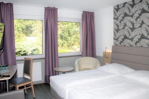 Postel nebo postele na pokoji v ubytování Hotel Erlenstegen