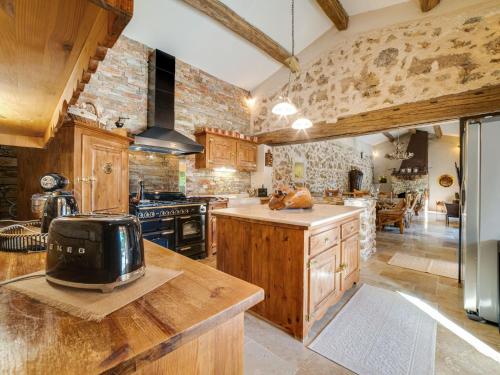 A kitchen or kitchenette at Stone holiday home with private pool