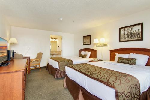 a hotel room with two beds and a flat screen tv at Bryce View Lodge Part of the Ruby's Inn Resort in Bryce Canyon