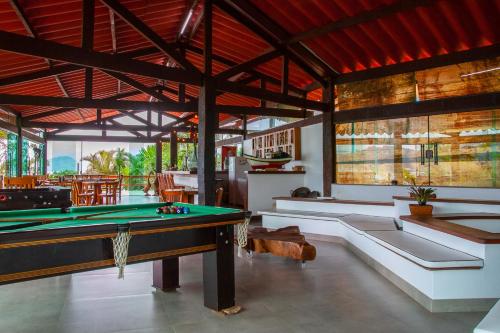 a room with a pool table in a house at Pousada e Restaurante Mangue Seco Angra in Angra dos Reis