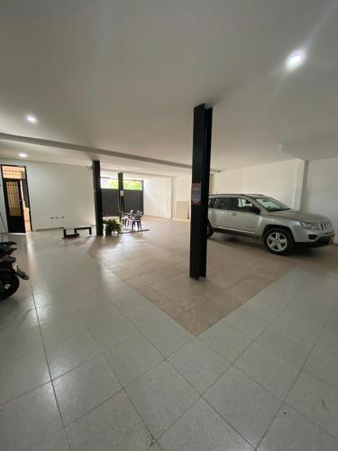 a parking lot with a car parked in a garage at CasaBlanca ApartaEstudios in Girardot