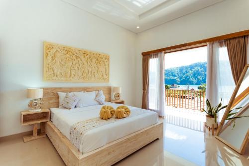 a bedroom with a bed with two dogs on it at Villa Jempana Kintamani in Kintamani
