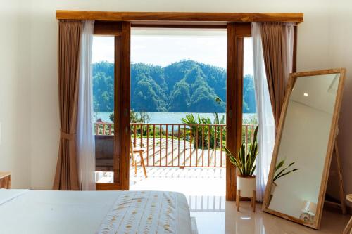 a bedroom with a view of the water at Villa Jempana Kintamani in Kintamani