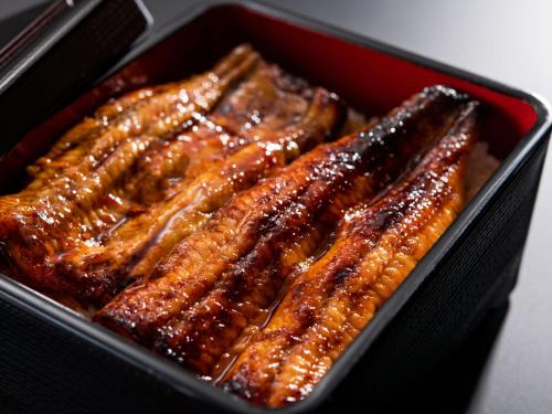 a tray of ribs in a red container at ART HOTEL Miyazaki Sky Tower in Miyazaki