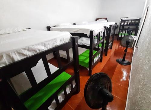 a group of four bunk beds in a room at Hotel Sol del Desierto in Villavieja
