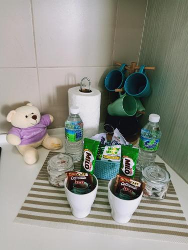 a table with some food and bottles of water at D'Gunduls Homestay STUDIO by DGH I-CITY in Shah Alam