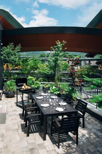 a table and chairs sitting on a patio at HOTEL KARUIZAWA CROSS in Karuizawa