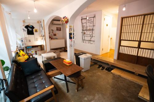 a living room with a couch and a table at Sato-san's Rest in Tokyo