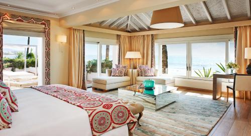 a bedroom with a bed and a living room at Marbella Club Hotel · Golf Resort & Spa in Marbella