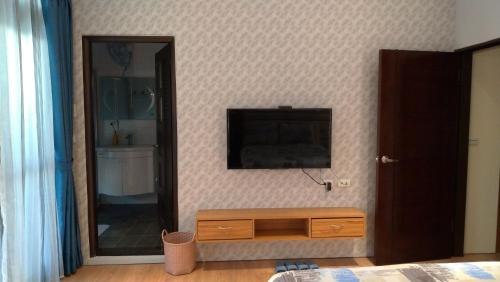 a bedroom with a mirror and a dresser and a bed at Host Garden悠禾園 in Hualien City
