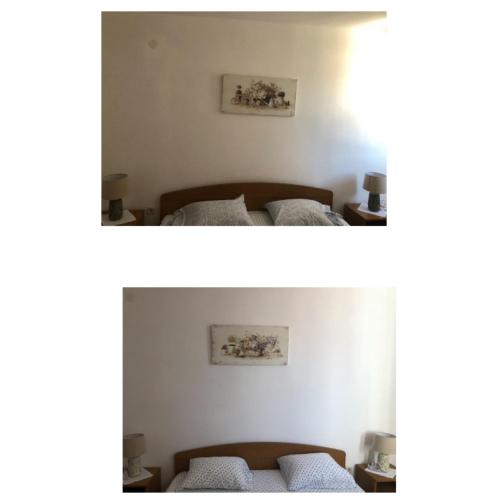 two beds in a room with two pictures on the wall at Guesthouse Tariba in Supetarska Draga
