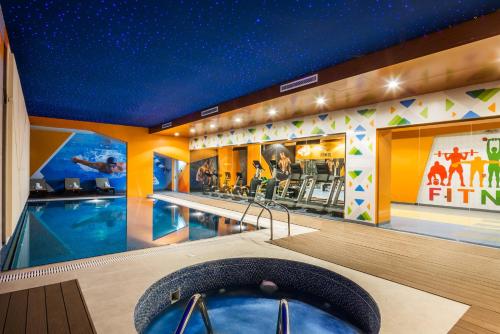 a hotel room with a swimming pool and a cinema at Art View Hotel - Riyadh Convention & Exhibition Center in Riyadh