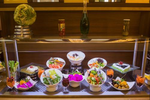 a buffet with different types of food on a table at Art View Hotel - Riyadh Convention & Exhibition Center in Riyadh