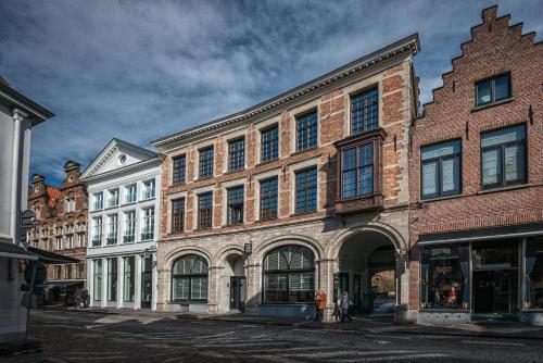 a group of buildings on a city street at Hotel Bourgoensch Hof in Bruges