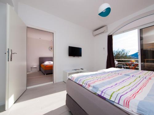 a bedroom with a bed and a sliding glass door at Apartments F & P in Dubrovnik