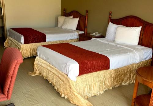 two beds in a hotel room withskirts at USA Inn in Alcoa