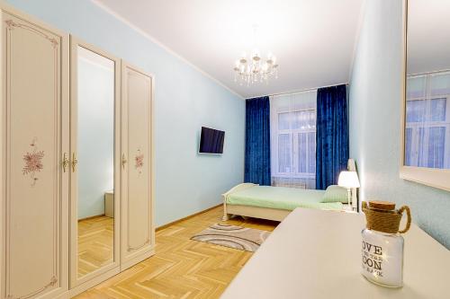 a room with a bed and a table in a room at Apartment Marata 10 in Saint Petersburg