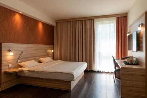 Säng eller sängar i ett rum på Star G Hotel Premium München Domagkstraße