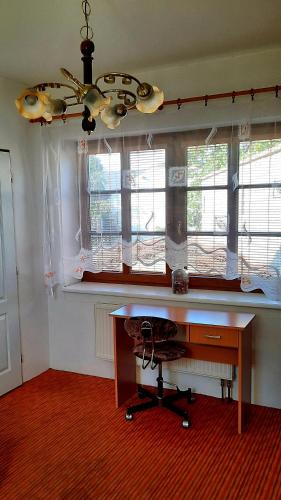 a room with a desk and a window with a ceiling at Penzion Na Figleně in Slatinice