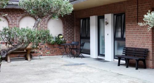 a brick building with benches and a table and chairs at Apartment "Lyon" in Korschenbroich