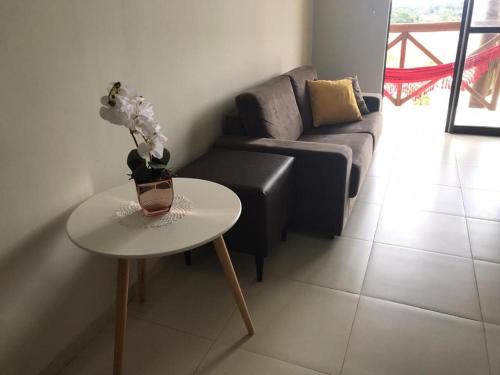 a living room with a couch and a table at Apartamento no Condomínio Sonhos da Serra - Bananeiras in Bananeiras