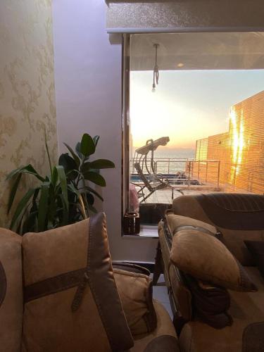 a living room with a view of the ocean at شاليهات لودج in Al Humaizah